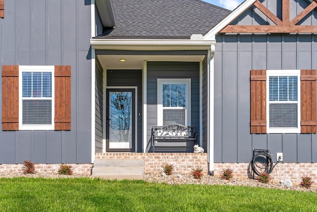 view of exterior entry featuring board and batten siding, a porch, and roof with shingles