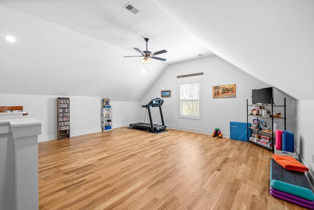interior space with lofted ceiling, visible vents, light wood-type flooring, baseboards, and ceiling fan