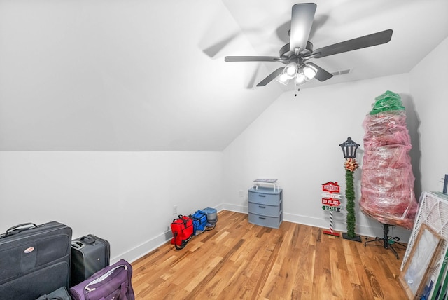 additional living space featuring lofted ceiling, a ceiling fan, baseboards, and wood finished floors