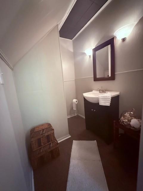 bathroom featuring lofted ceiling and vanity