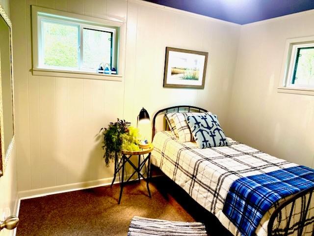 bedroom featuring baseboards, carpet floors, and ornamental molding