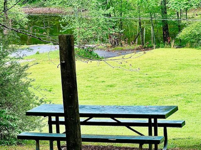 surrounding community featuring a yard and a water view