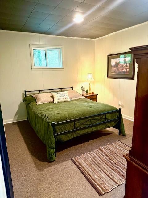 bedroom with carpet floors, crown molding, and baseboards