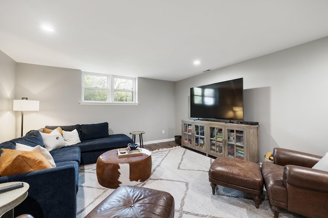 living room with baseboards, wood finished floors, and recessed lighting
