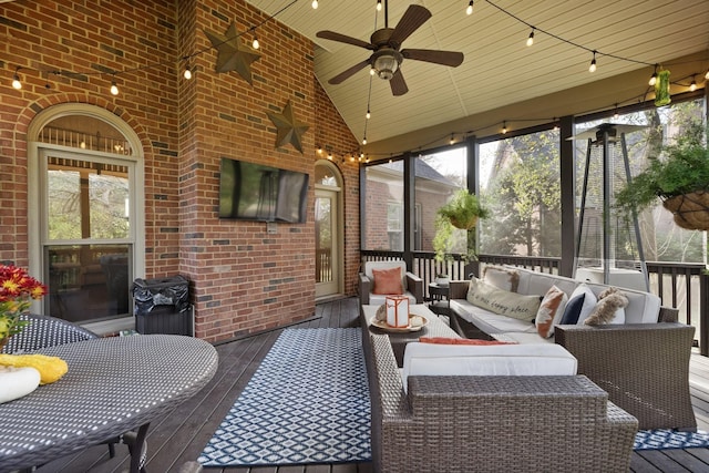 sunroom / solarium with an outdoor living space, a ceiling fan, and a healthy amount of sunlight