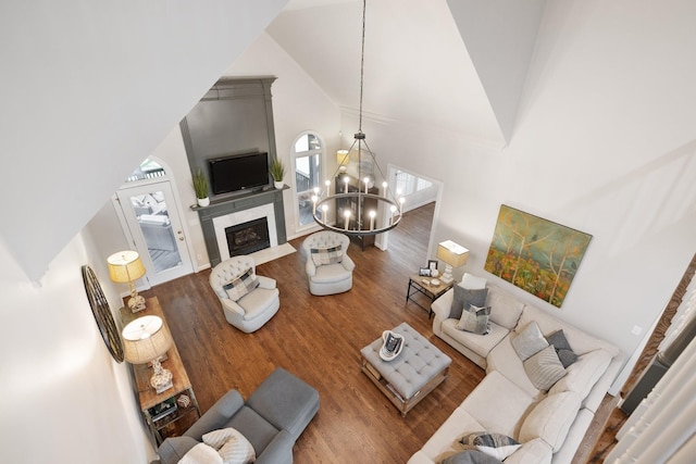 living room featuring wood finished floors, a healthy amount of sunlight, and high vaulted ceiling