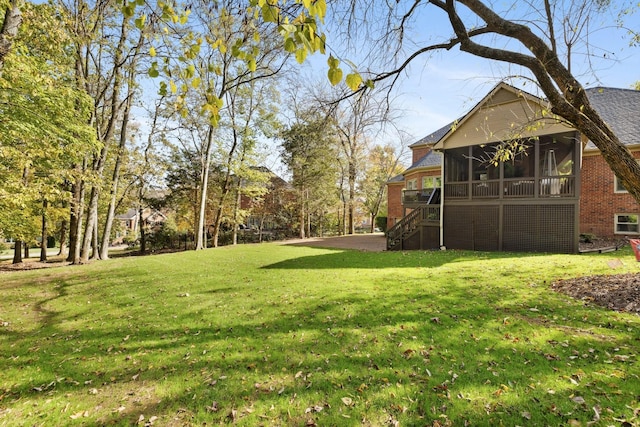 view of yard with a sunroom and stairs