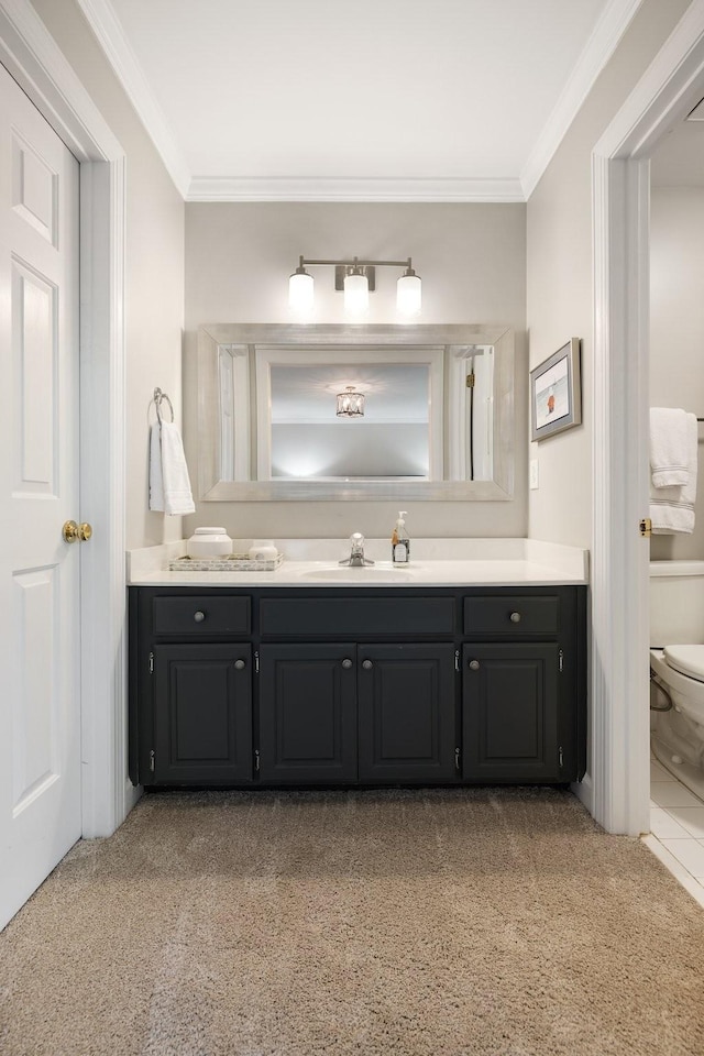 bathroom with toilet, crown molding, vanity, and carpet floors