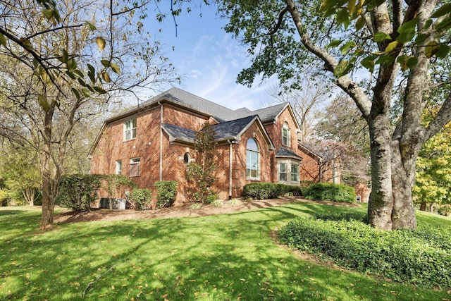 view of front of home with brick siding and a front yard