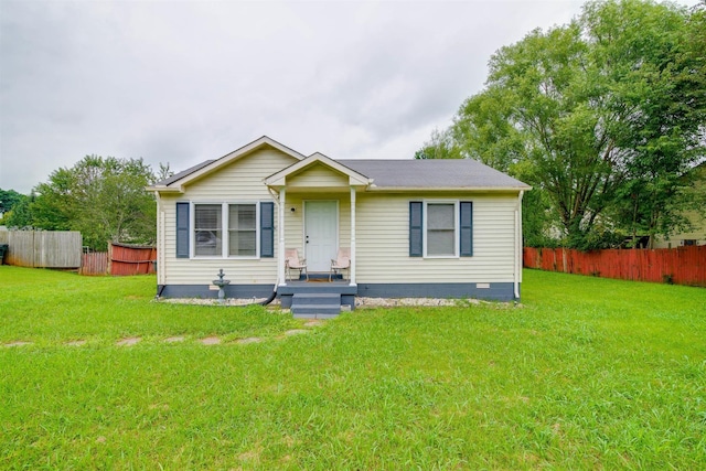 view of front of home with fence and a front yard