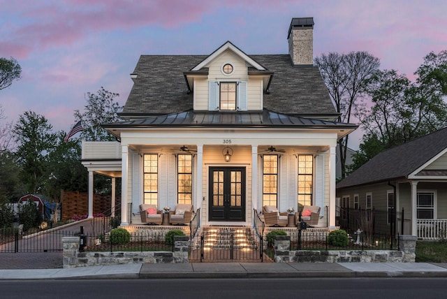 305 Natchez St, Franklin, TN 37064 - view of front of house with covered porch, a standing seam roof, french doors, and a fenced front yard