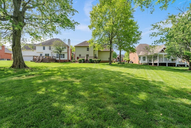 view of yard with a wooden deck and a residential view