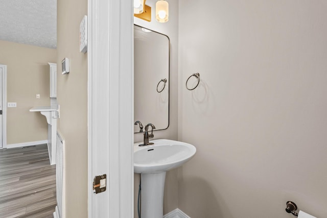 bathroom featuring wood finished floors and baseboards