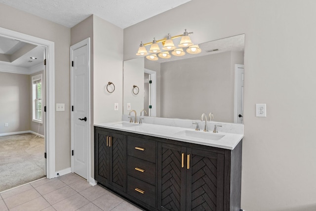 full bath with double vanity, a sink, tile patterned floors, and baseboards