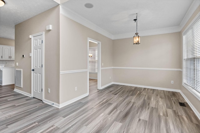 unfurnished dining area with visible vents, baseboards, and light wood-style floors