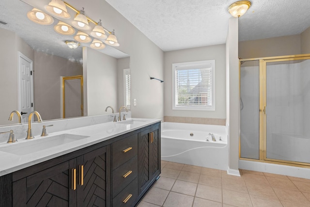 bathroom featuring double vanity, a bath, a stall shower, and a sink