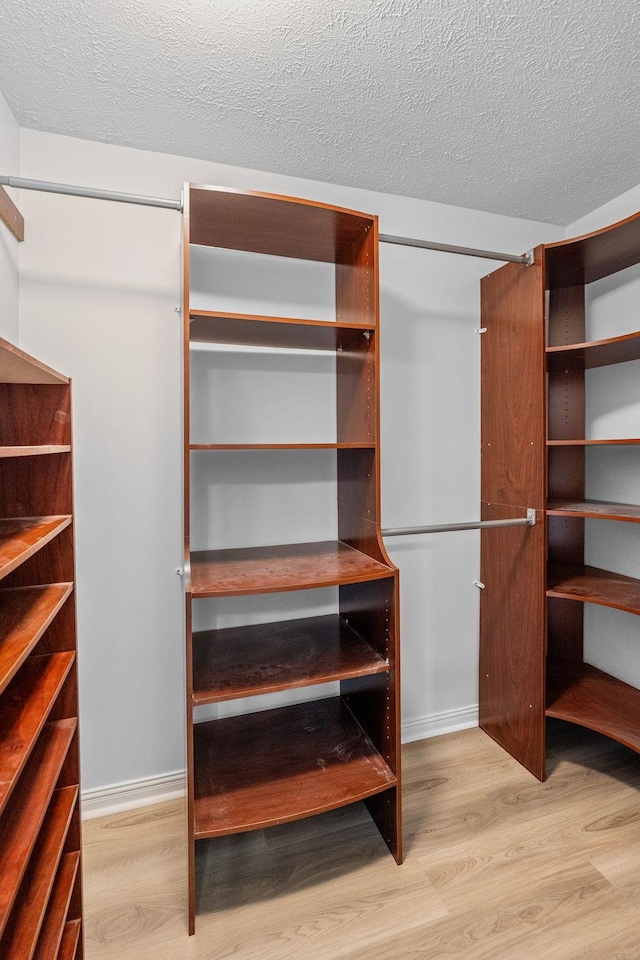 spacious closet with wood finished floors