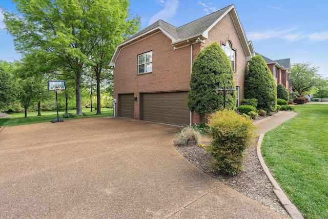 view of home's exterior featuring brick siding, a yard, concrete driveway, and an attached garage