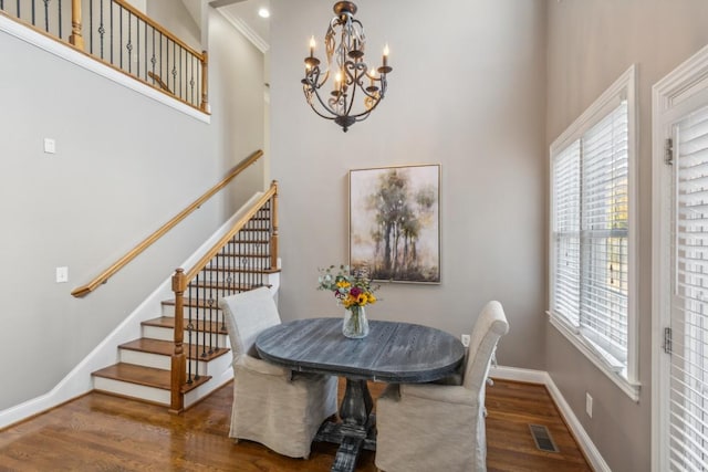 638 Band Dr, Franklin, TN 37064 - dining room with wood finished floors, a chandelier, stairway, a high ceiling, and healthy amount of natural light