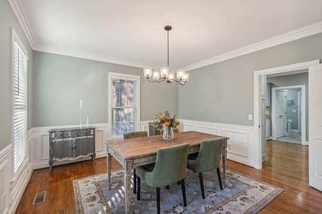 638 Band Dr, Franklin, TN 37064 - dining space featuring a chandelier, crown molding, a decorative wall, wood finished floors, and a wainscoted wall