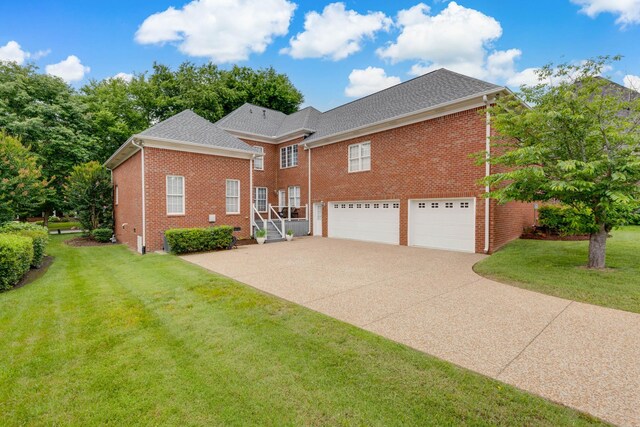 638 Band Dr, Franklin, TN 37064 - view of property exterior featuring an attached garage, concrete driveway, brick siding, and a lawn