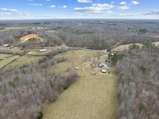 drone / aerial view featuring a rural view and a view of trees