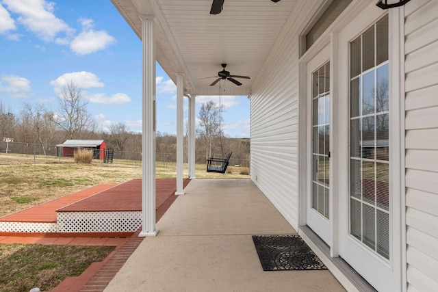 view of patio featuring a ceiling fan and fence