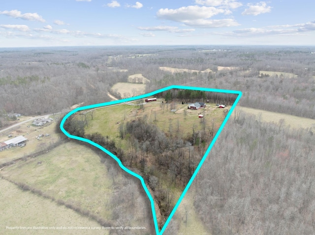 aerial view featuring a wooded view and a rural view
