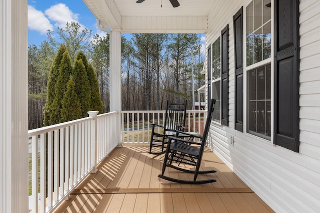wooden terrace featuring a porch and a ceiling fan