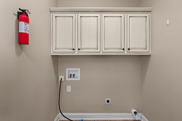 laundry area featuring cabinet space, washer hookup, baseboards, and hookup for an electric dryer