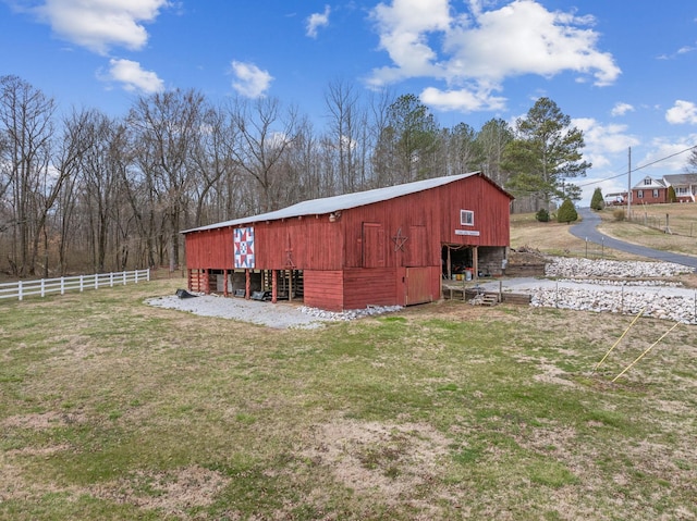 view of outbuilding with an outbuilding and fence