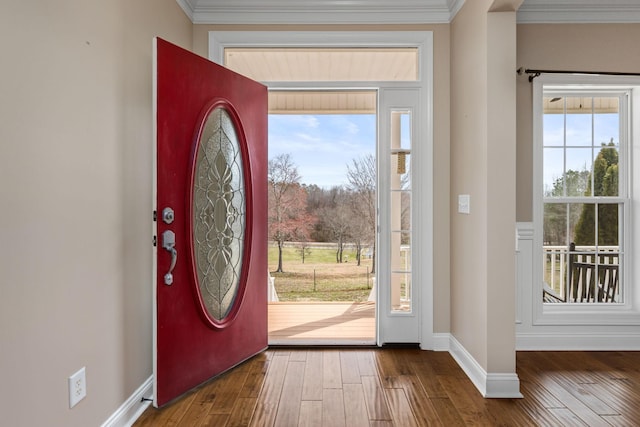 foyer featuring crown molding, baseboards, and wood-type flooring