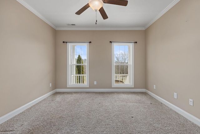 spare room with light colored carpet, a ceiling fan, ornamental molding, and visible vents