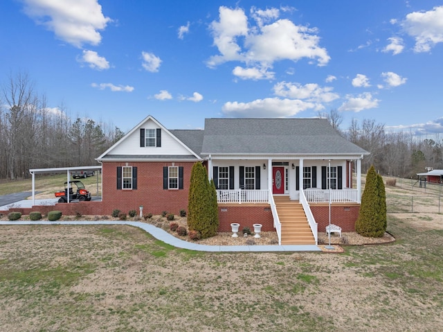 view of front of property with a carport, covered porch, stairs, and brick siding