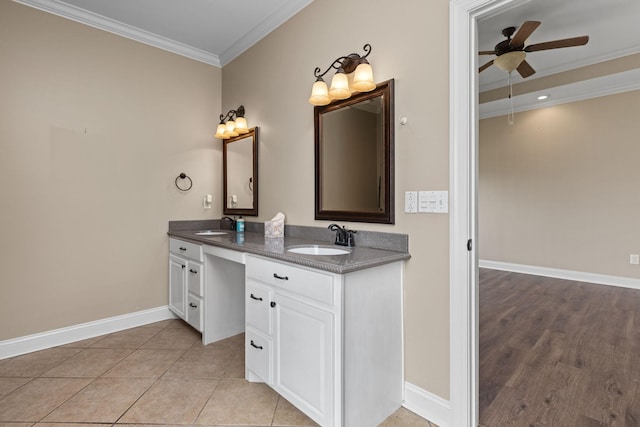 bathroom featuring baseboards, a sink, ceiling fan, and crown molding