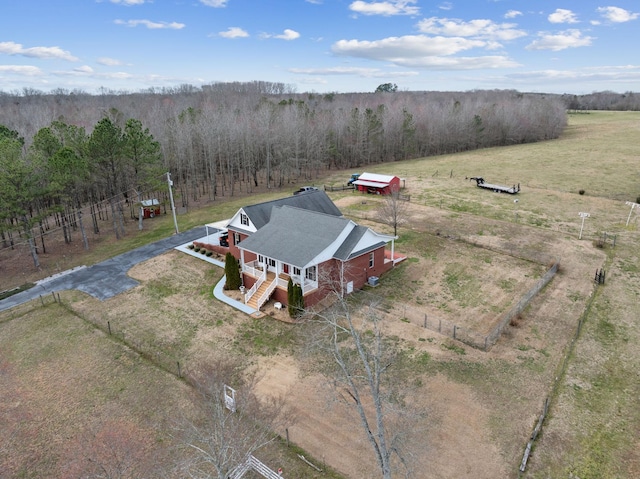birds eye view of property with a rural view and a wooded view