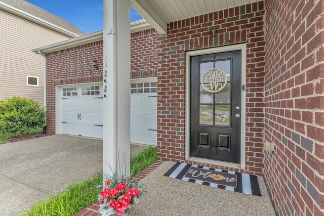 155 Telavera Dr, White House, TN 37188 - view of exterior entry with driveway, a garage, and brick siding