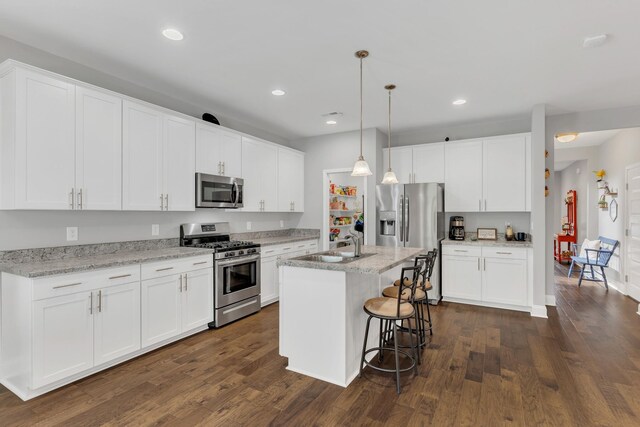 155 Telavera Dr, White House, TN 37188 - kitchen with white cabinetry, stainless steel appliances, and dark wood finished floors