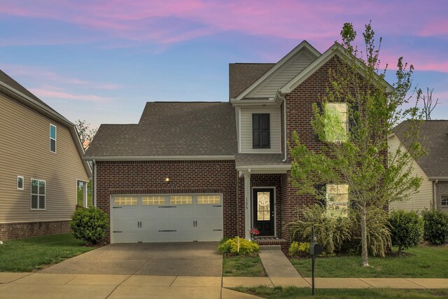 155 Telavera Dr, White House, TN 37188 - traditional home featuring brick siding, driveway, roof with shingles, a front lawn, and an attached garage