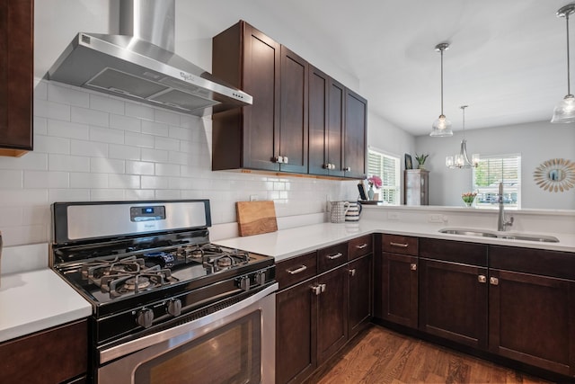 5604 Kentucky Ave, Nashville, TN 37209 - kitchen featuring stainless steel range with gas cooktop, wall chimney range hood, light countertops, and a sink