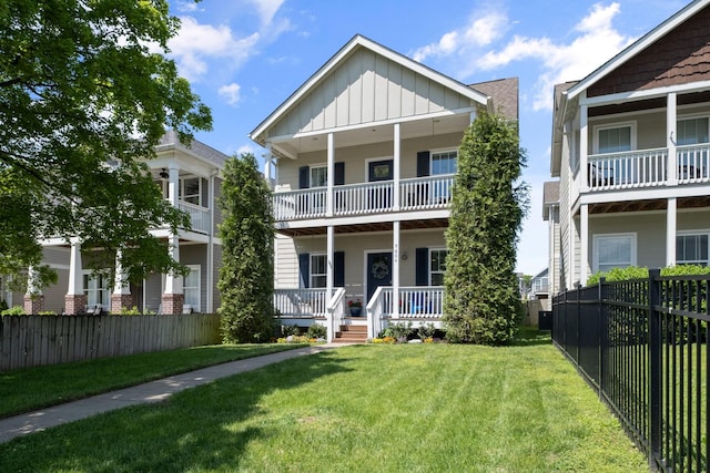 5604 Kentucky Ave, Nashville, TN 37209 - view of front facade featuring a fenced backyard, a front lawn, a porch, and board and batten siding