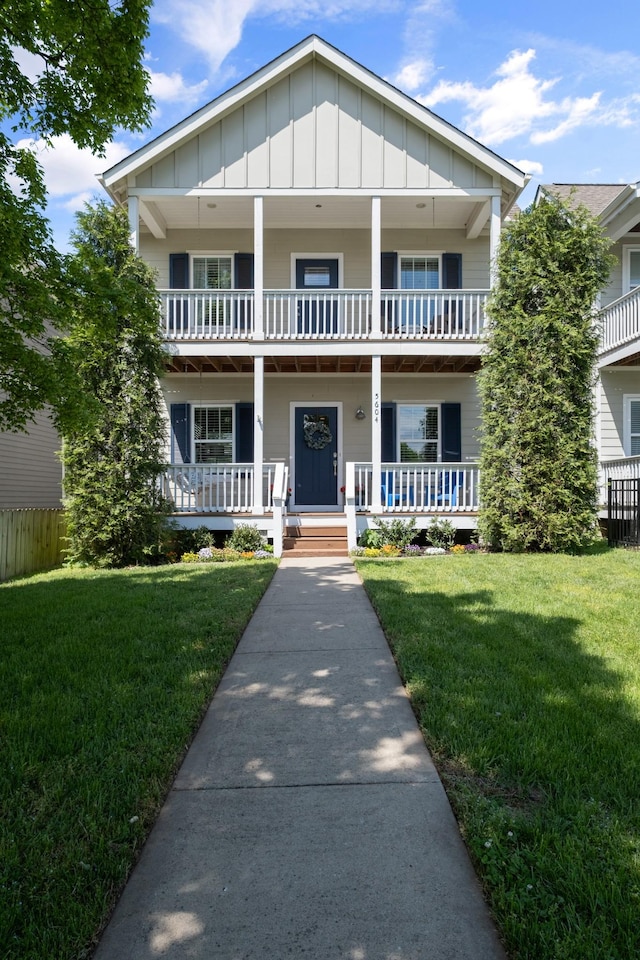 5604 Kentucky Ave, Nashville, TN 37209 - view of front facade featuring board and batten siding, a balcony, a front yard, and covered porch