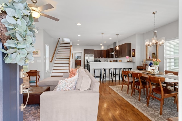 5604 Kentucky Ave, Nashville, TN 37209 - living area featuring ceiling fan with notable chandelier, wood finished floors, recessed lighting, and stairway