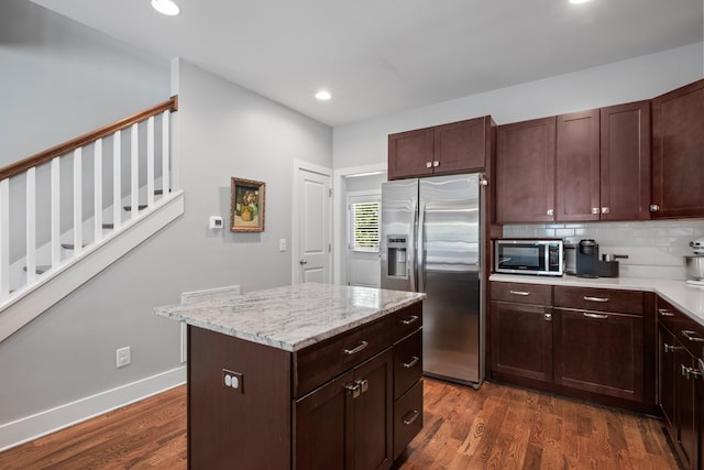 5604 Kentucky Ave, Nashville, TN 37209 - kitchen featuring recessed lighting, dark wood finished floors, stainless steel appliances, a center island, and decorative backsplash