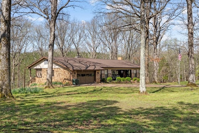 ranch-style house with a chimney, a front lawn, brick siding, and a garage