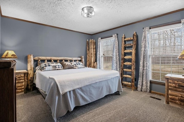 bedroom with visible vents, carpet flooring, a textured ceiling, and crown molding