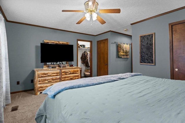 bedroom featuring a textured ceiling, baseboards, visible vents, carpet, and ceiling fan