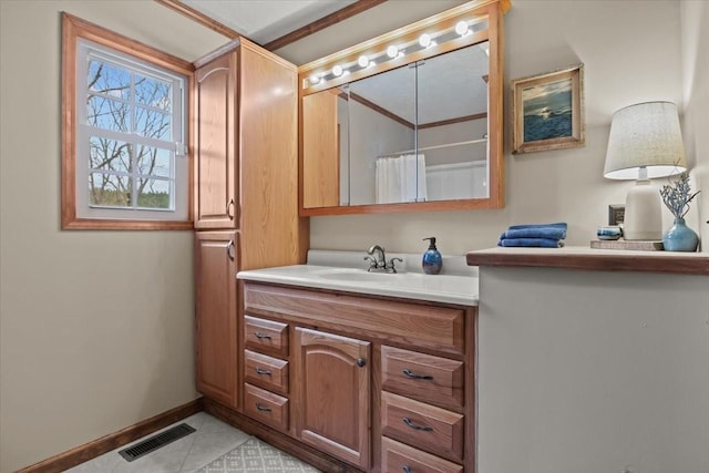 bathroom featuring baseboards, visible vents, tile patterned flooring, and vanity