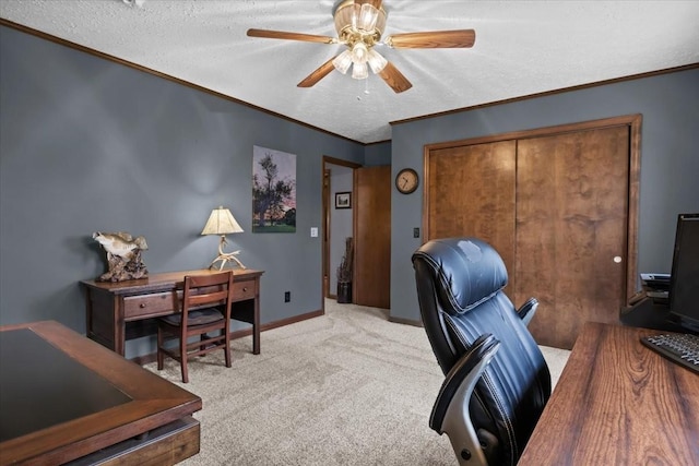 carpeted office space with a textured ceiling, a ceiling fan, and ornamental molding