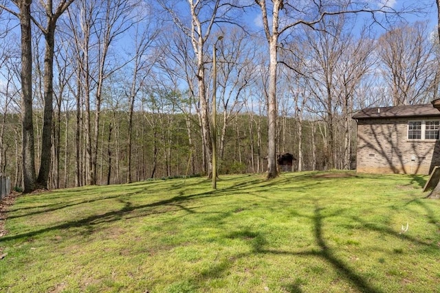 view of yard with a view of trees